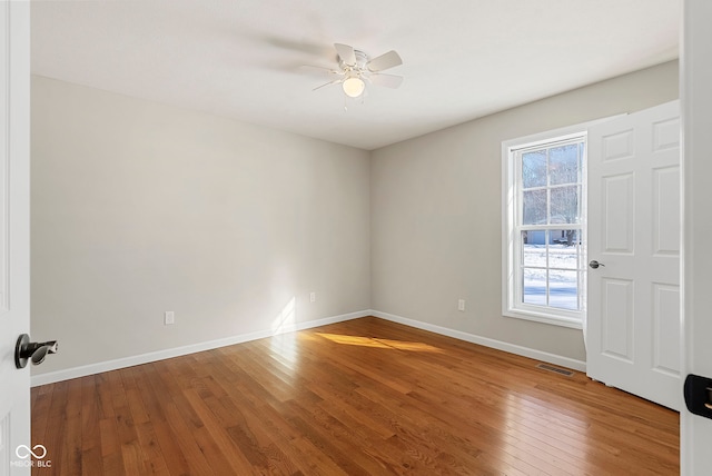 spare room featuring ceiling fan and hardwood / wood-style flooring