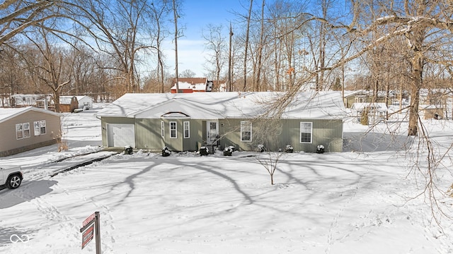 view of snow covered back of property