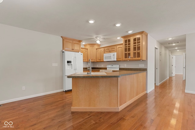 kitchen featuring ceiling fan, sink, kitchen peninsula, light hardwood / wood-style floors, and white appliances