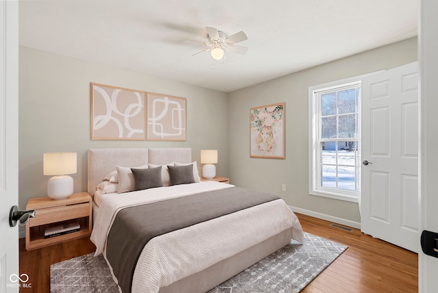 bedroom with ceiling fan and hardwood / wood-style floors