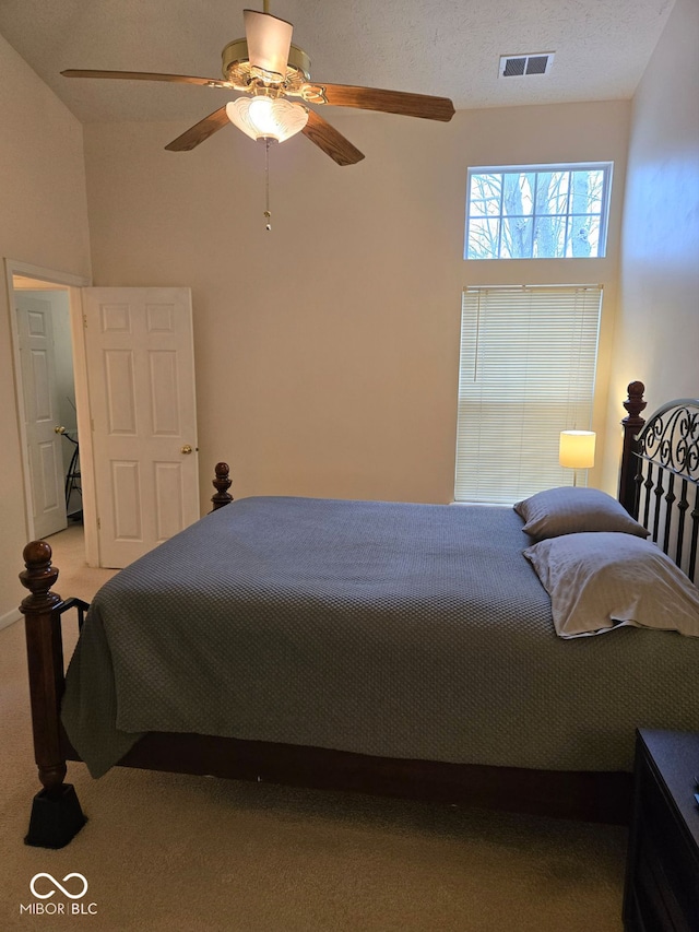 bedroom featuring light colored carpet and ceiling fan