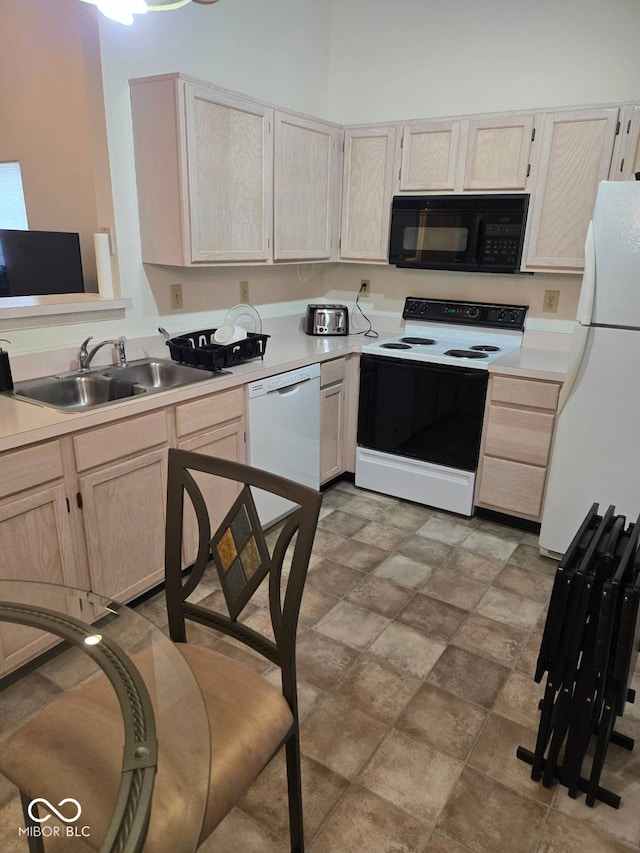 kitchen featuring sink, white appliances, and light brown cabinets