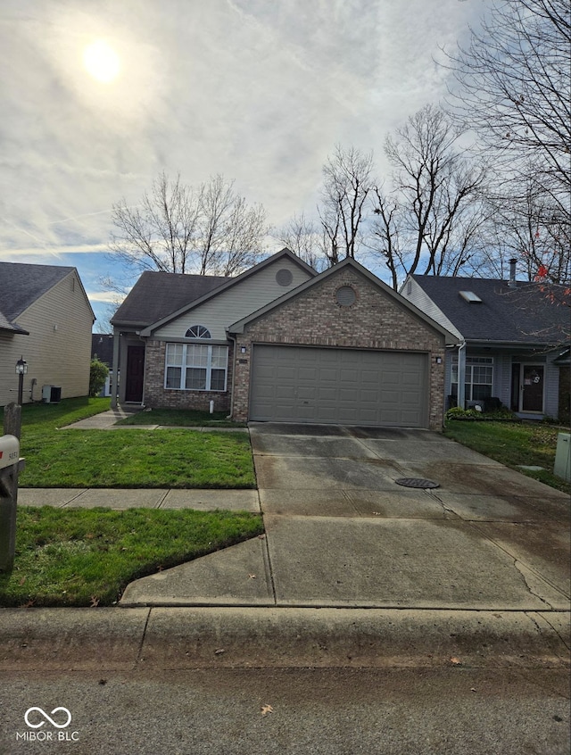 view of front facade featuring a garage, a front lawn, and central air condition unit