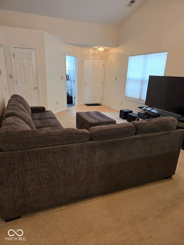 carpeted living room featuring lofted ceiling