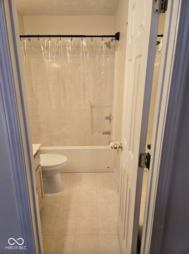 full bathroom featuring vanity, shower / bath combo, tile patterned floors, toilet, and a textured ceiling