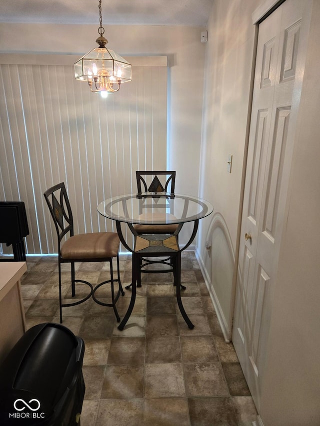 dining space featuring a notable chandelier