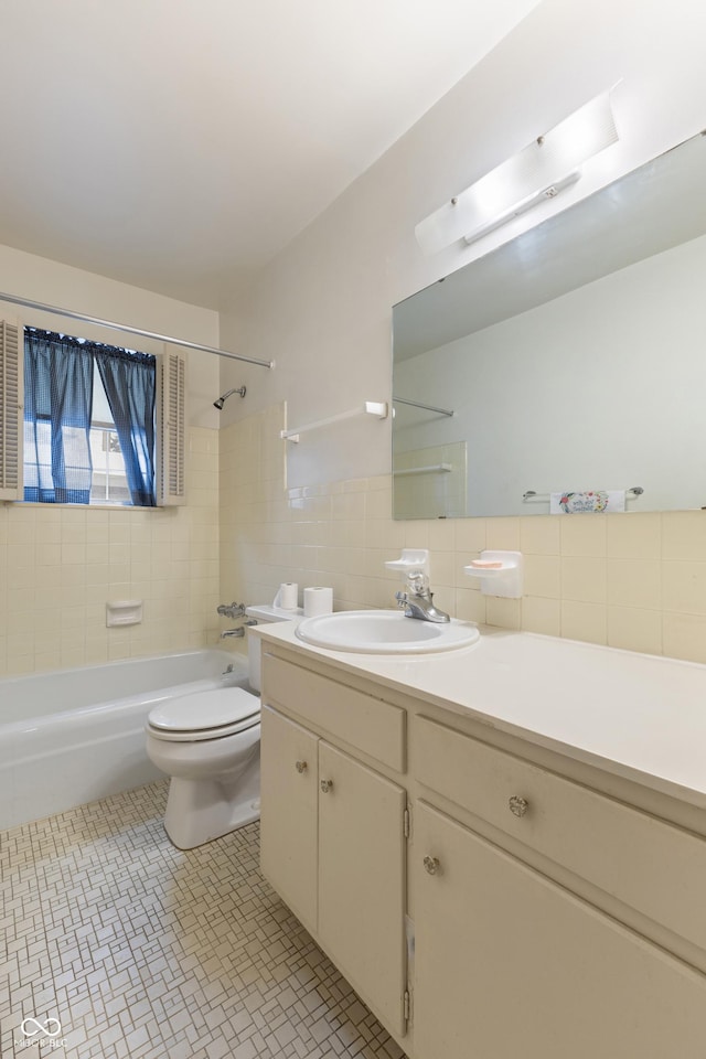 full bathroom with toilet, tasteful backsplash, tiled shower / bath, tile walls, and vanity