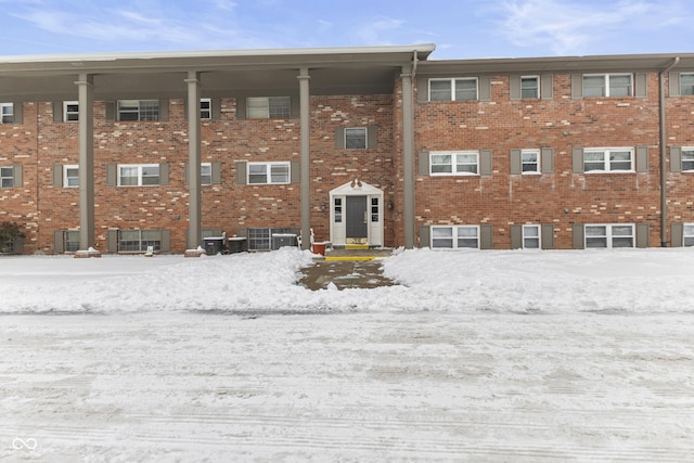 snow covered property with cooling unit