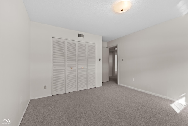 unfurnished bedroom with a closet and carpet