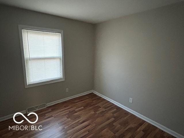 empty room featuring dark hardwood / wood-style floors