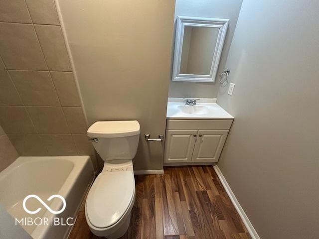 bathroom featuring a bathing tub, vanity, toilet, and wood-type flooring