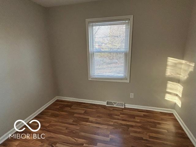 empty room with dark wood-type flooring