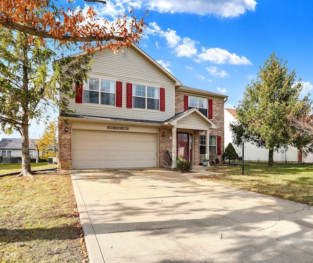 view of front of property with a garage and a front lawn