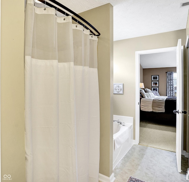 bathroom featuring independent shower and bath and a textured ceiling