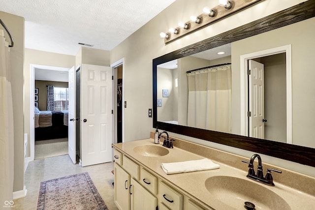 bathroom featuring vanity and a textured ceiling