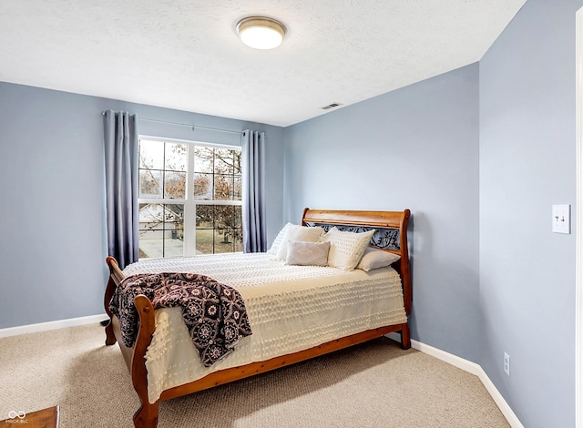 carpeted bedroom featuring a textured ceiling