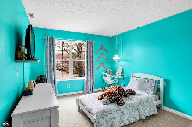 carpeted bedroom featuring a textured ceiling