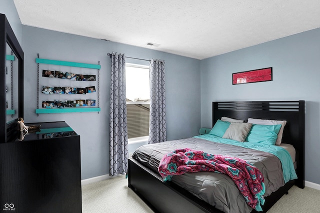 carpeted bedroom featuring a textured ceiling