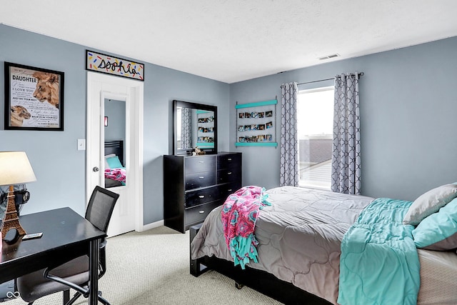 bedroom featuring a textured ceiling and carpet floors