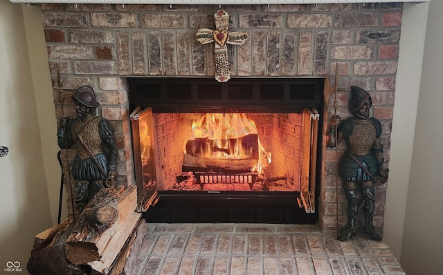 interior details featuring a brick fireplace