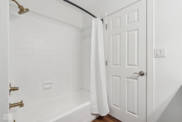 bathroom featuring shower / tub combo with curtain and wood-type flooring