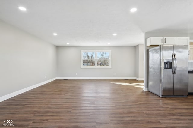 kitchen featuring stainless steel fridge with ice dispenser, dark hardwood / wood-style floors, and white cabinets