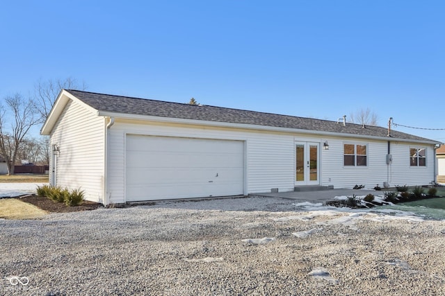 view of front of house with a garage and french doors