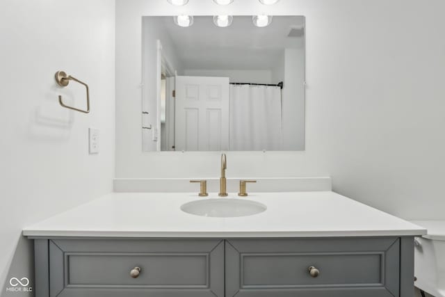 bathroom featuring vanity and toilet