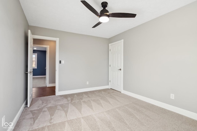 unfurnished bedroom with light colored carpet and ceiling fan