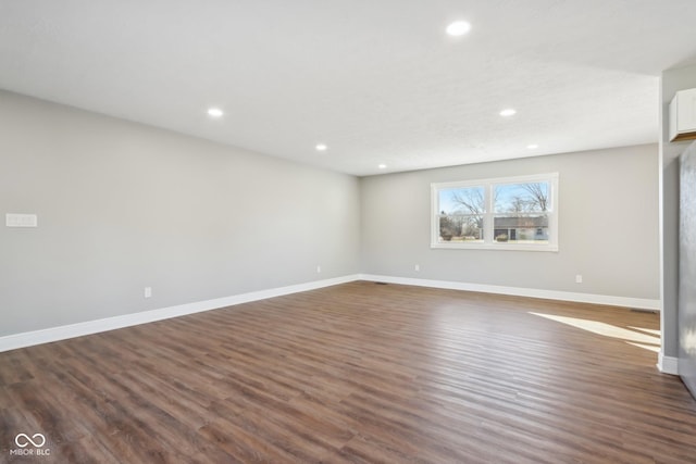 spare room with dark hardwood / wood-style floors