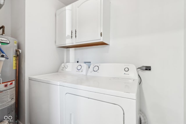 laundry room with washer and dryer, cabinets, and water heater