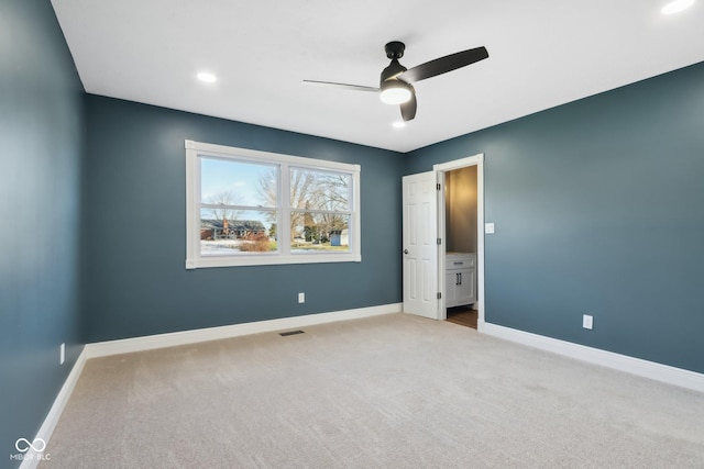 unfurnished bedroom featuring ceiling fan and light colored carpet