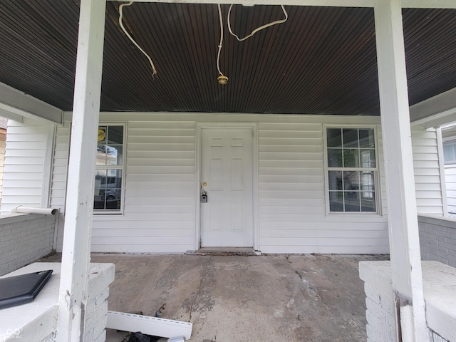 view of exterior entry with a porch