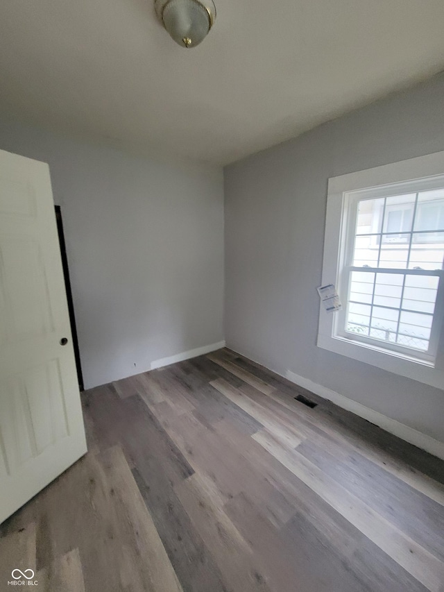 spare room with light hardwood / wood-style flooring