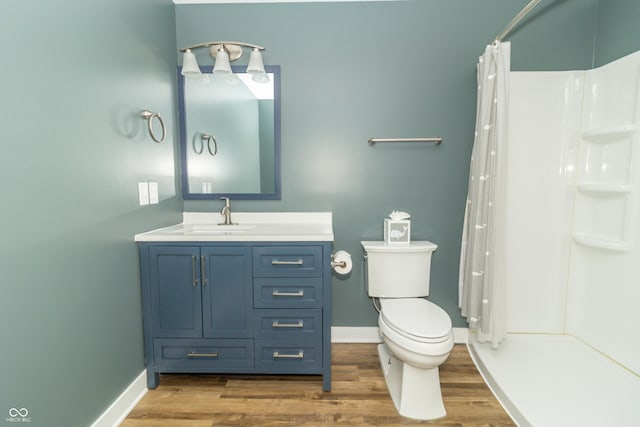 bathroom with a shower with shower curtain, vanity, toilet, and wood-type flooring