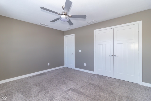 unfurnished bedroom featuring carpet, a closet, and ceiling fan