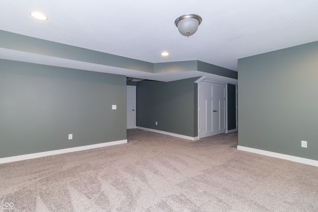 basement featuring light carpet