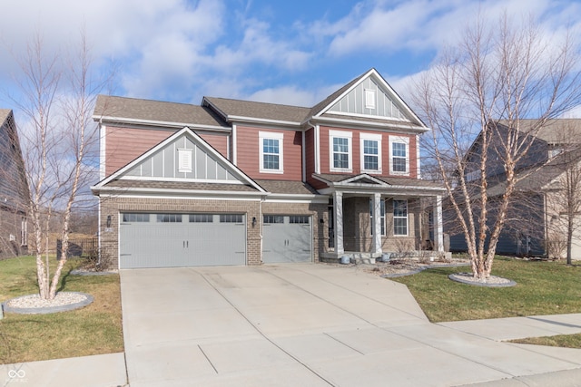 craftsman inspired home with a garage and a front lawn