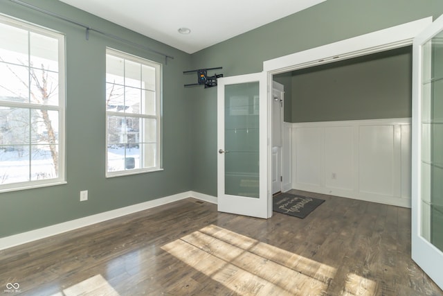 unfurnished room featuring dark wood-type flooring and french doors