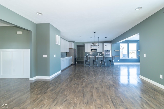 unfurnished living room with dark hardwood / wood-style flooring