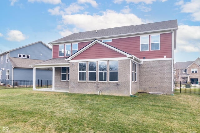 back of property with a lawn and a patio area