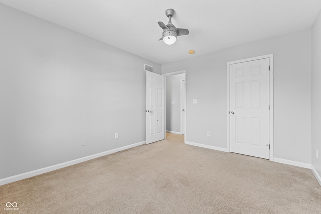 unfurnished bedroom with light colored carpet and ceiling fan