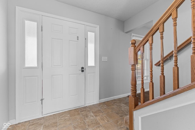 foyer entrance featuring a textured ceiling