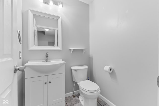 bathroom featuring tile patterned floors, vanity, and toilet