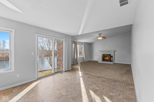 unfurnished living room with ceiling fan and lofted ceiling