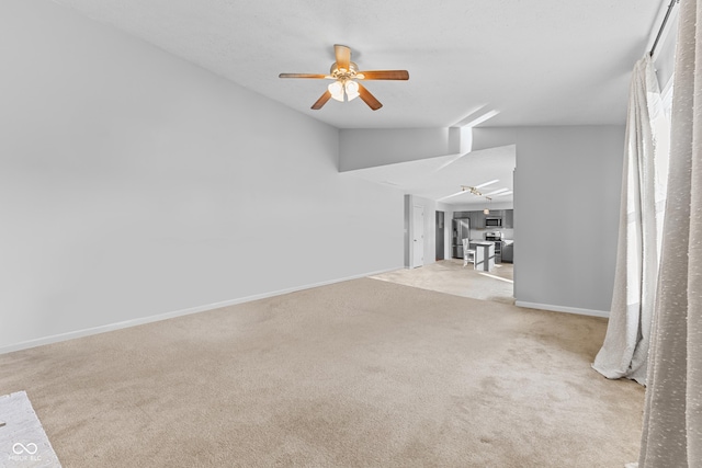 unfurnished living room featuring light carpet, ceiling fan, and lofted ceiling