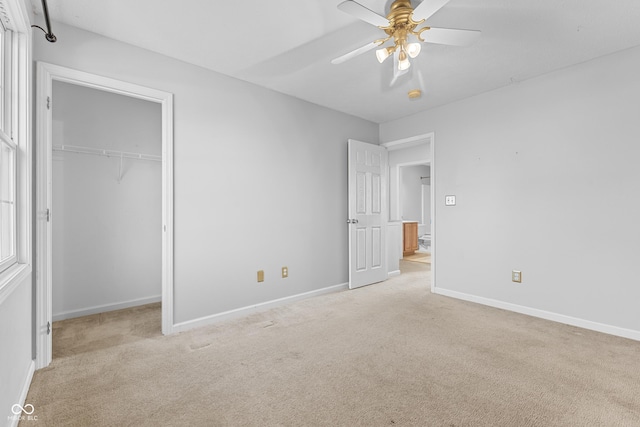 unfurnished bedroom featuring ceiling fan, light carpet, and a closet