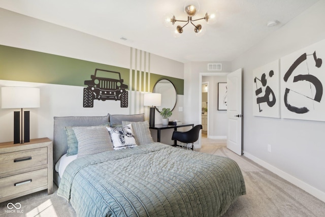 carpeted bedroom featuring a notable chandelier