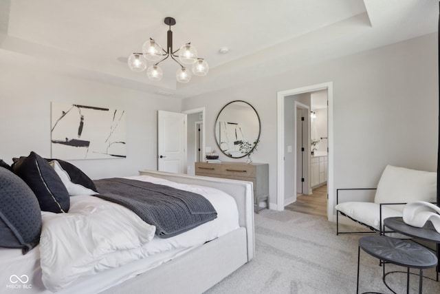 bedroom featuring light carpet, an inviting chandelier, and a raised ceiling