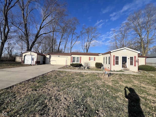 single story home with a front yard and a garage